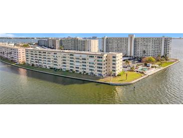 Aerial view of waterfront condo building with pool and parking at 6075 Shore S Blvd # 103, Gulfport, FL 33707