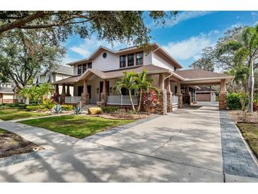 Two-story home with a wraparound porch and paver driveway at 15927 Ternglade Dr, Lithia, FL 33547