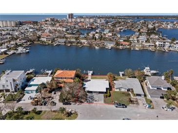 Aerial view of a waterfront home with private dock and pool at 17020 Dolphin Dr, North Redington Beach, FL 33708