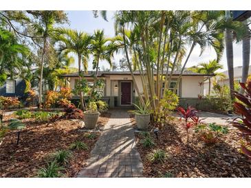 Cute bungalow home with lush landscaping and a brick walkway at 216 23Rd N Ave, St Petersburg, FL 33704