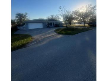 Charming single-story home with a well-maintained lawn and an attached garage at 22065 Malone Ave, Port Charlotte, FL 33952