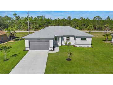 Aerial view of a single-story house with a gray roof and driveway at 25434 Alicante Dr, Punta Gorda, FL 33955