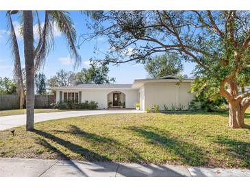 Charming single-story home with mature landscaping and a spacious front yard at 3310 Carib Rd, Tampa, FL 33618