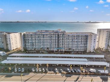 Aerial view of a waterfront building with parking and bay views at 6020 Shore S Blvd # 101, Gulfport, FL 33707