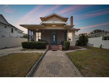 Charming bungalow with a screened porch and brick walkway at 834 11Th N St, St Petersburg, FL 33705