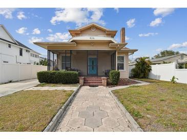 Quaint house with a screened porch and brick walkway at 834 11Th N St, St Petersburg, FL 33705