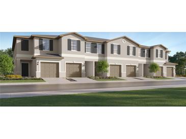 Modern 2-story townhouses with attached garages and landscaping at 5210 Meyer Bessie St, Zephyrhills, FL 33541