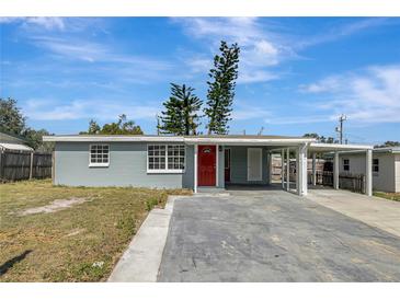 Newly renovated home featuring a carport and red front door at 10515 118Th Ave, Largo, FL 33773