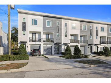 Modern townhome community with attached garages and landscaped yards at 1501 N Morgan St # 7, Tampa, FL 33602