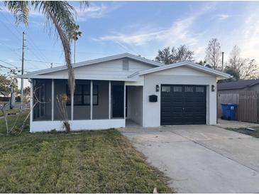 Updated single story home with a modern garage door and screened porch at 1798 Shore Acres Ne Blvd, St Petersburg, FL 33703