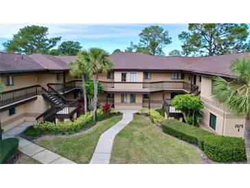 Well-maintained condo building with lush landscaping and a welcoming entrance at 2679 Sabal Springs Cir # 102, Clearwater, FL 33761