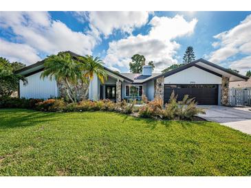 Beautiful mid-century modern home with landscaped lawn and updated facade at 2973 Somersworth Dr, Clearwater, FL 33761