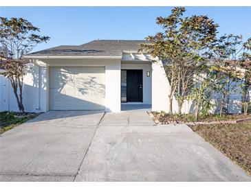 Updated exterior of house with a newly paved driveway and landscaping at 6411 Monterey Blvd, Tampa, FL 33625