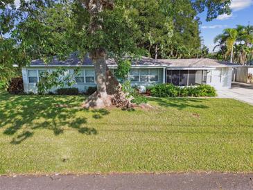 Charming single-story home with a spacious lawn and mature trees at 731 74Th N St, St Petersburg, FL 33710