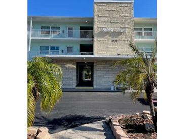 ShoreView 1810 building exterior, featuring two stories, balconies, and palm trees at 1819 Shore S Dr # 210, South Pasadena, FL 33707