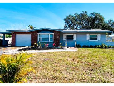 Charming single-story home with a well-maintained lawn and colorful landscaping at 12361 114Th St, Largo, FL 33778