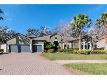 Beautiful two-story home with a three-car garage and lush landscaping at 13904 Shadow Tree Ln, Tampa, FL 33618