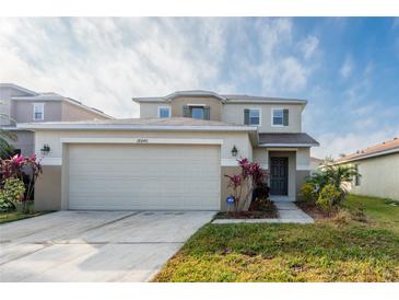 Two-story house with attached garage and landscaping at 18840 Parapet Pl, Land O Lakes, FL 34638