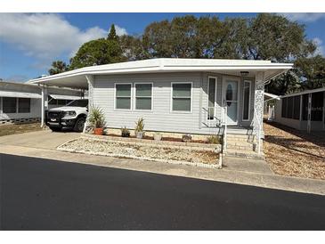 Charming home featuring an attached carport, landscaped yard, and well-maintained exterior at 3301 Alt 19 # 126, Palm Harbor, FL 34683