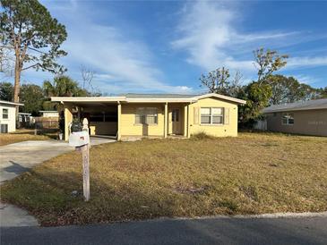 Ranch-style house with a well-maintained lawn and single car garage at 5163 Jasmine Cir, St Petersburg, FL 33714