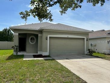 One-story house with a two-car garage and well-maintained lawn at 929 Windton Oak Dr, Ruskin, FL 33570