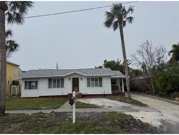 Charming single story home with a spacious yard and mature palm trees at 944 Bruce Ave, Clearwater Beach, FL 33767