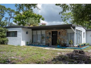 Ranch style home with a stone accent and well-manicured lawn at 5601 9Th N Ave, St Petersburg, FL 33710