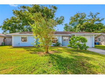 Light blue house with a well-maintained lawn and driveway at 10 N Mercury Ave, Clearwater, FL 33765