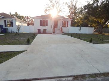 Charming single-story home with a large concrete driveway and well-maintained front yard at 10008 N 20Th St, Tampa, FL 33612