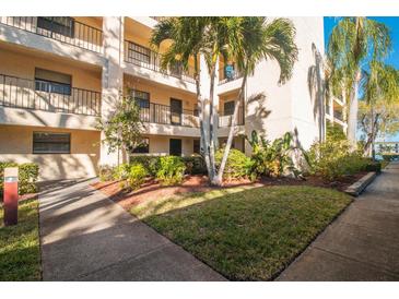 Lush landscaping surrounds this condo building, offering a welcoming entrance at 11485 Oakhurst Rd # A301, Largo, FL 33774