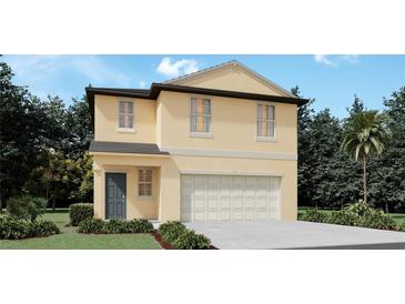 Two-story house with a two-car garage and landscaping at 13574 Newbridge St, Spring Hill, FL 34609