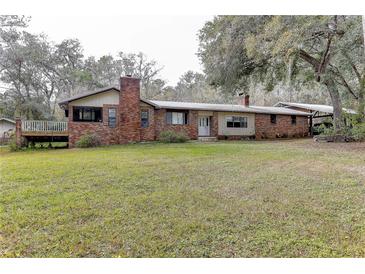 Brick ranch house with large yard and carport at 20490 Pinewood Dairy Rd, Brooksville, FL 34601