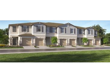 Front view of townhouses with attached garages and landscaping at 2637 Sunray Venus Way, Ruskin, FL 33570