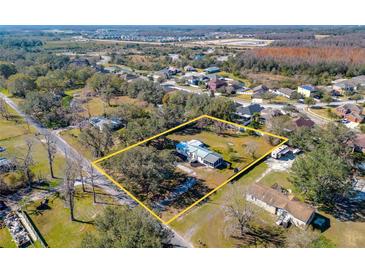 Aerial view showing a single-Gathering home on a large lot with surrounding trees at 3749 Loury Dr, Wesley Chapel, FL 33543