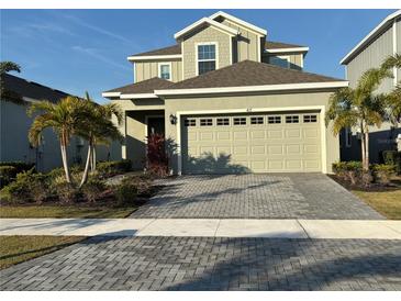 Charming two-story home featuring a spacious two-car garage and a beautifully paved driveway at 417 Sandsend Ct, Apollo Beach, FL 33572