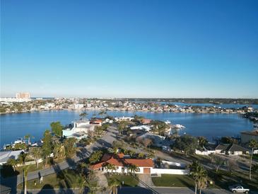 Aerial view of waterfront home with surrounding houses and waterways at 430 173Rd E Ave, North Redington Beach, FL 33708