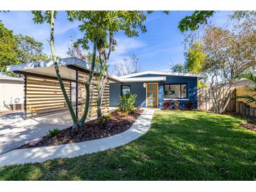 Charming mid-century modern home with landscaped yard and carport at 664 60Th S St, St Petersburg, FL 33707