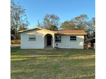 Charming single-story home with stucco siding, arched entryway, and well-maintained lawn at 477 88Th N Ave, St Petersburg, FL 33702