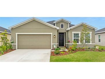 Single-Gathering home with two-car garage and landscaped yard at 10023 Eventide Trl, Parrish, FL 34219