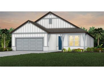 Beautiful craftsman style home with gray and white exterior, two car garage and landscaping at 1267 Kazaz Ct, Zephyrhills, FL 33540