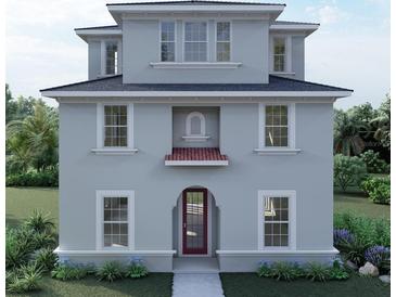 Two-story house with gray siding, red door, and landscaping at 3024 W Cass St, Tampa, FL 33609