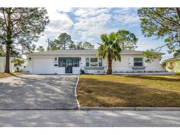 White single story home with landscaped lawn and gated driveway at 5214 25Th N Ave, St Petersburg, FL 33710