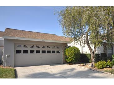 Attractive single-story home with a two-car garage and well-maintained landscaping at 5565 Salem Square N Dr, Palm Harbor, FL 34685