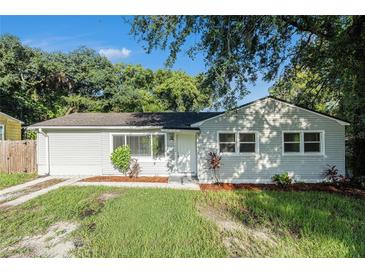 Newly renovated light gray house with a spacious lawn at 7202 N 21St St, Tampa, FL 33610