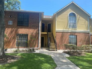 Brick building exterior with stairs and landscaping at 8615 Mallard Reserve Dr # 102, Tampa, FL 33614