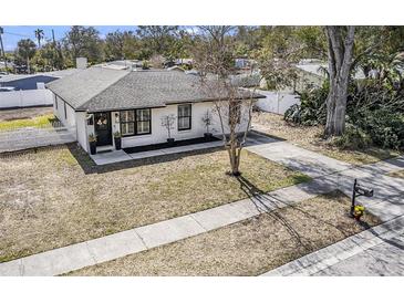 Charming home featuring a well-manicured lawn, elegant front door, and a welcoming walkway at 1002 7Th S St, Safety Harbor, FL 34695