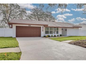 Newly renovated house with a modern exterior and a well-maintained lawn at 130 19Th St, Palm Harbor, FL 34683