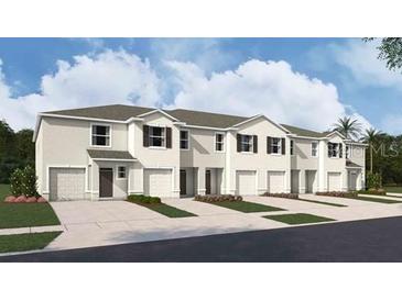 New townhome community with attached garages and landscaping at 31277 Midnight Sun Way, Wesley Chapel, FL 33545
