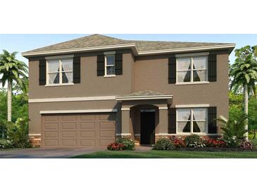 Two-story house with brown exterior, a two-car garage, and landscaping at 10596 Farm Hill Ave, Land O Lakes, FL 34638