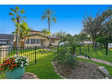 Charming house with a manicured lawn, walkway, and lush landscaping at 156 29Th N Ave, St Petersburg, FL 33704